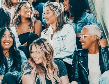 group of ladies sitting together on stairs