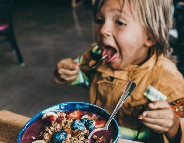 toddler eating healthy yogurt bowl