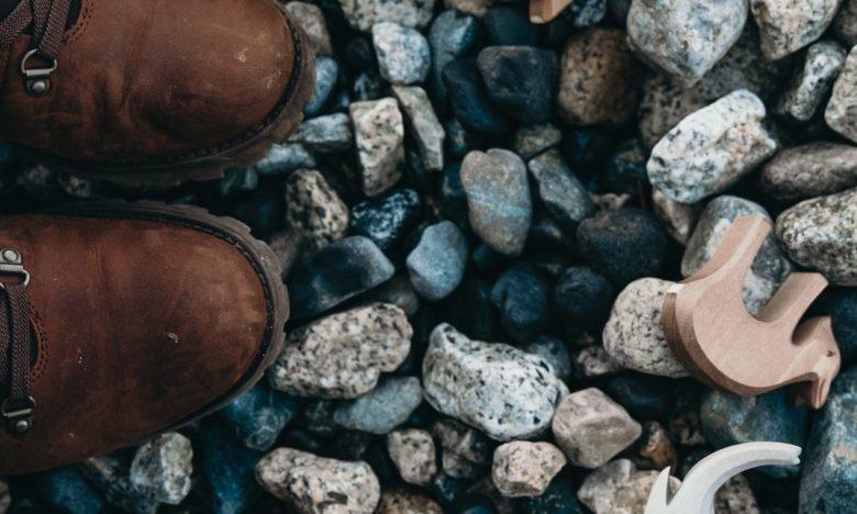 top view of child's shoe and toy on pebbles