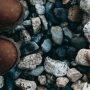 top view of child's shoe and toy on pebbles