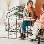 woman speaking with woman sitting in wheelchair