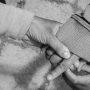 black and white photo of mother lovingly holds child's hand