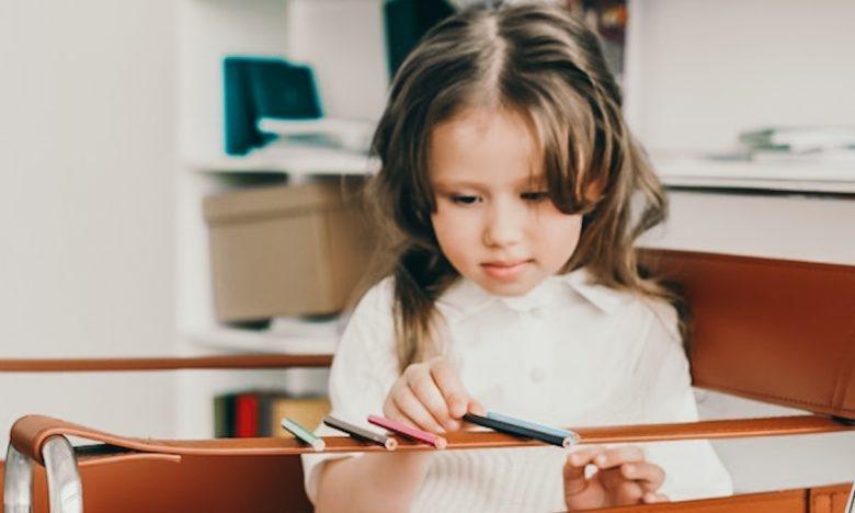 special needs girl sharpening pencil in session