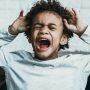 boy upset and crying in chair