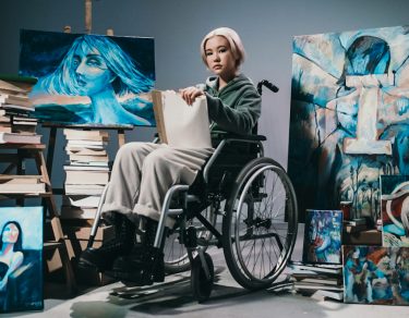 Artist with a disability displaying her art.