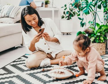 Protect your child's privacy online - mom taking photo of toddler