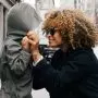 Mom pulling hoodie over child's head