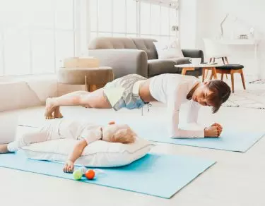 mom exercising beside sleeping baby