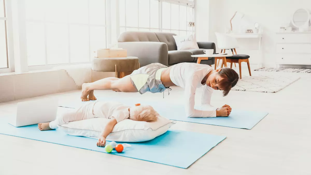 mom exercising beside sleeping baby