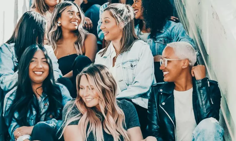 group of ladies sitting together on stairs