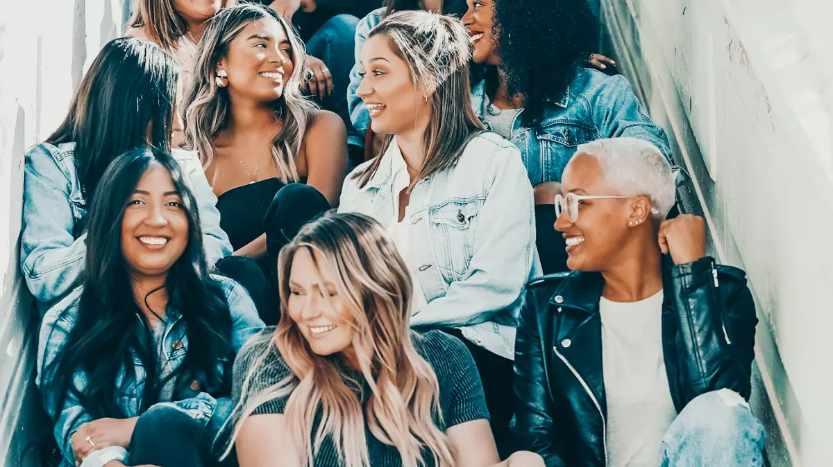 group of ladies sitting together on stairs