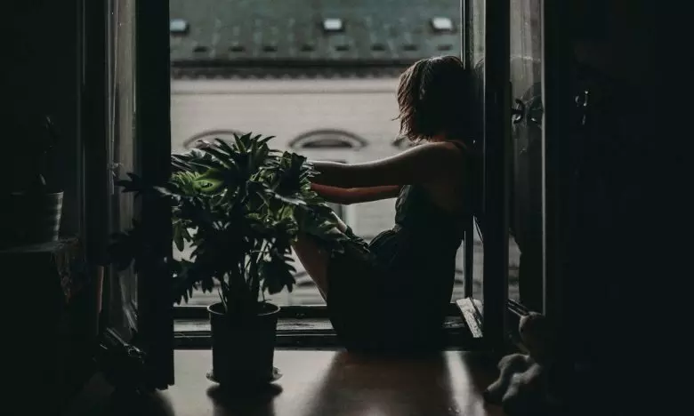 woman sitting on floor looking out