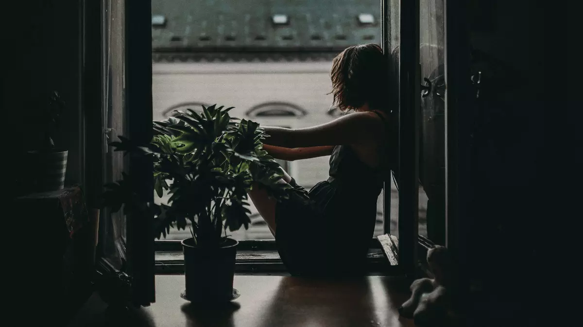 woman sitting on floor looking out