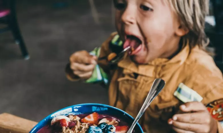 toddler eating healthy yogurt bowl