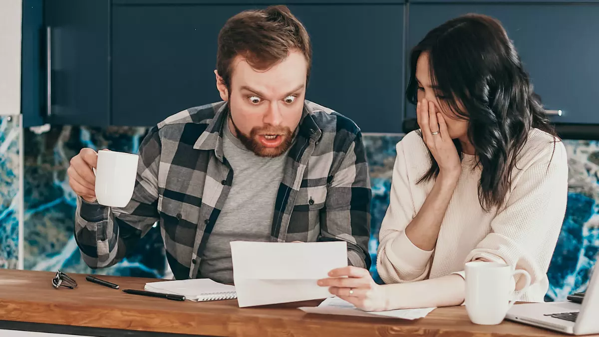 surprised man looking at paper woman shows him