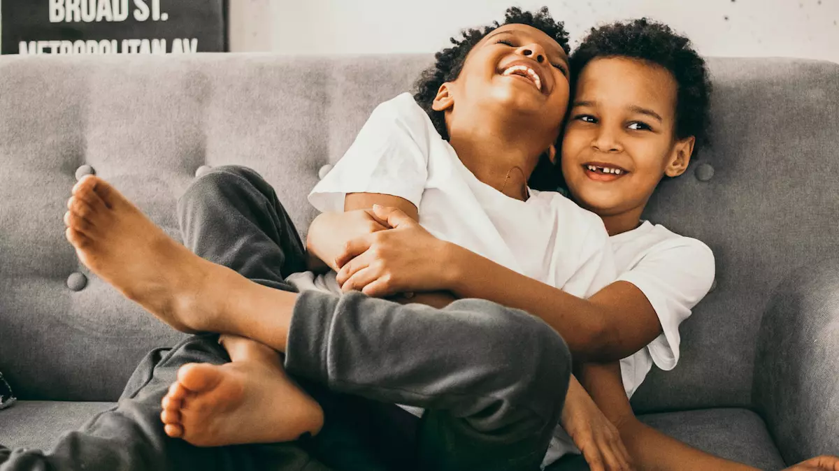 brother wraps legs around sibling while they both laugh