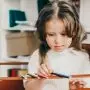 special needs girl sharpening pencil in session