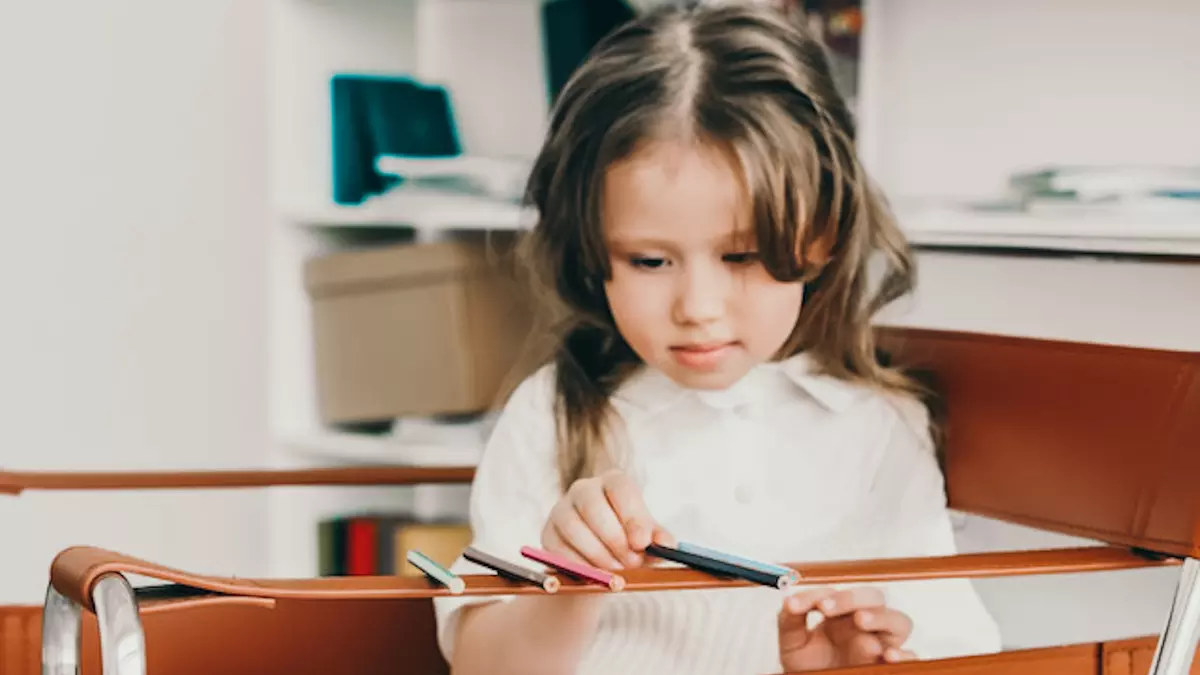 special needs girl sharpening pencil in session