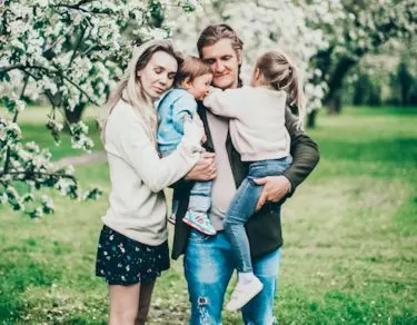 family of 3 posing for photo