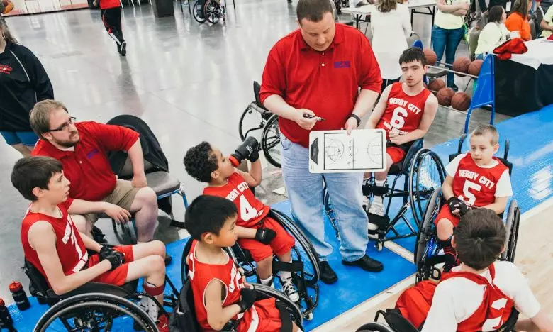 coach talking to special needs basket ball team
